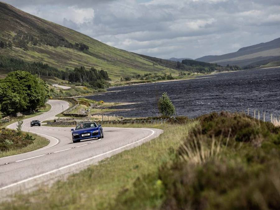 Blue Audi driving through the countryside