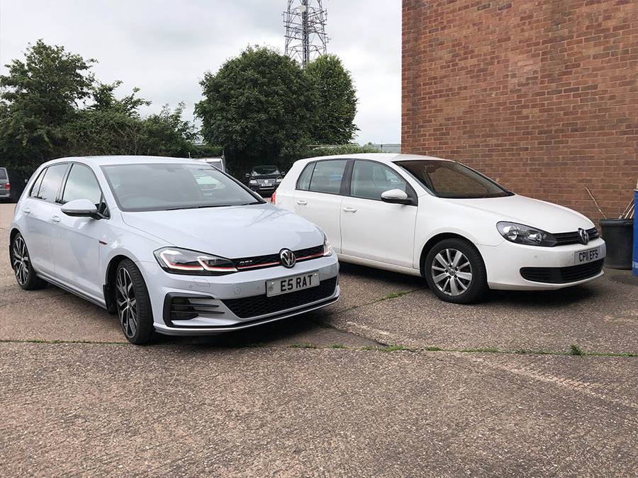 Two white Volkswagens parked on the Performance Driven forecourt